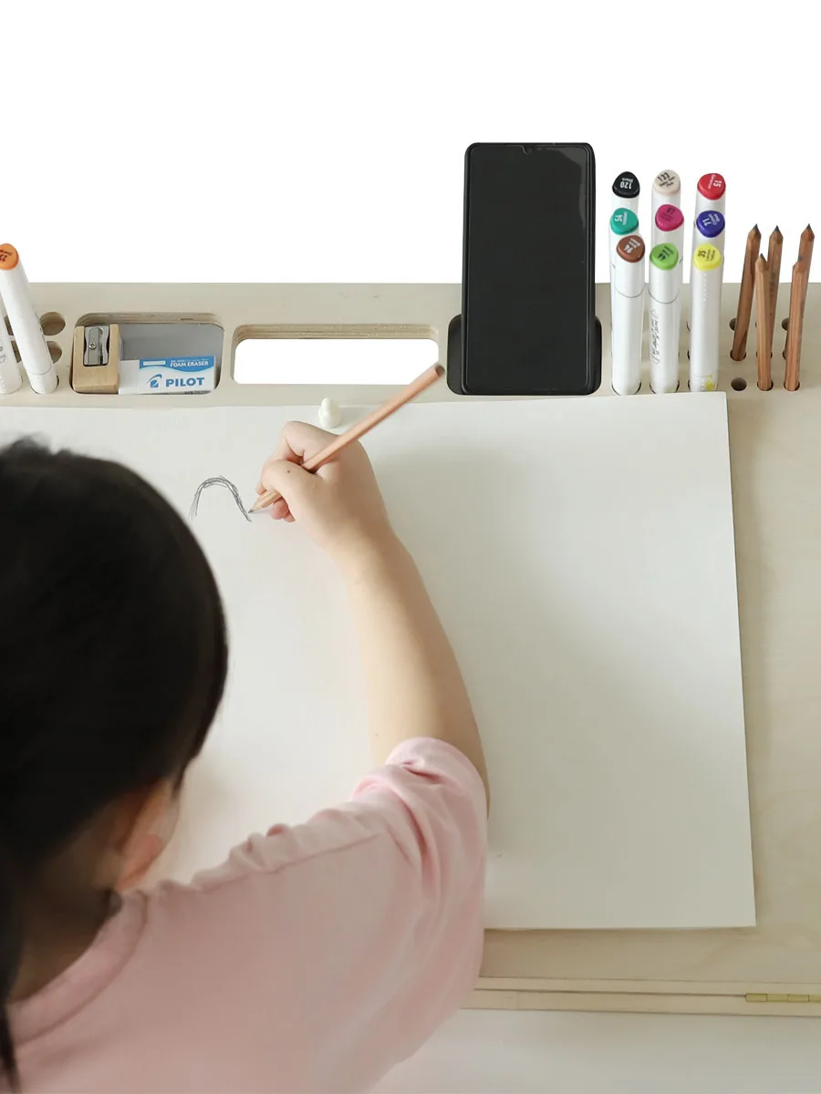 Adjustable drawing board in use for pencil sketching in studio