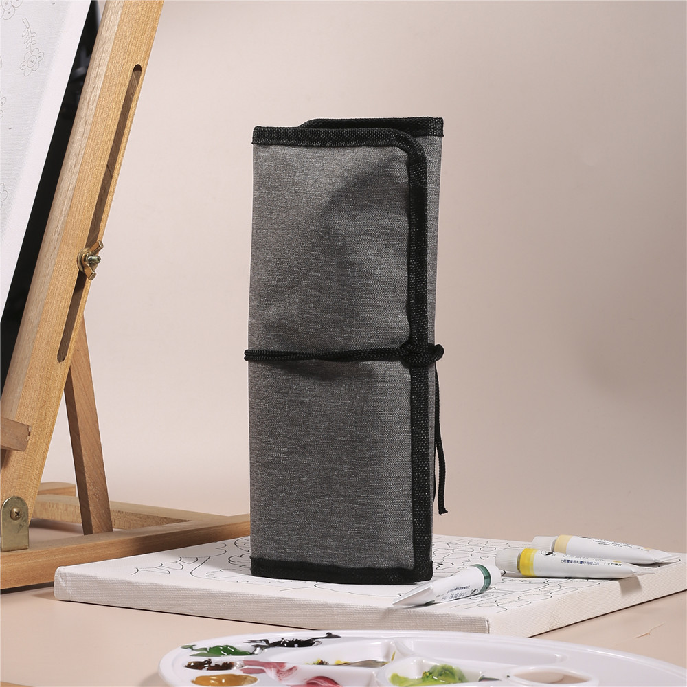 Paintbrush storage case rolled up and tied closed for travel