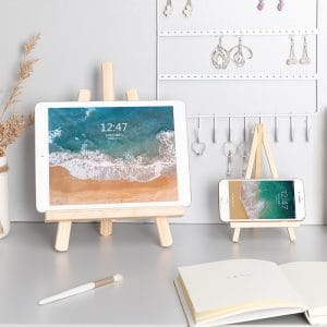 Wooden tablet stand holding phone upright on desk