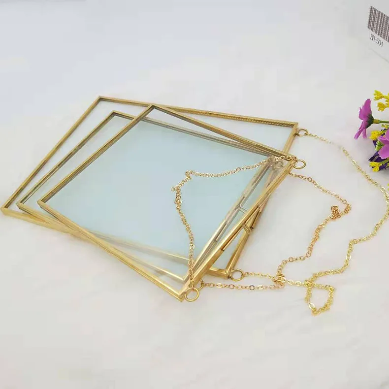 Brass and glass floating frame displayed on shelf in modern interior