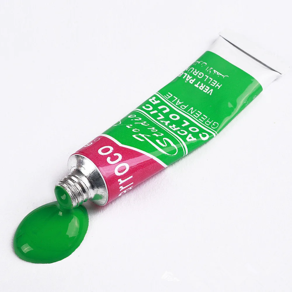 Green acrylic paint tube from acrylic paint set with brush with fresh paint squeezed out
