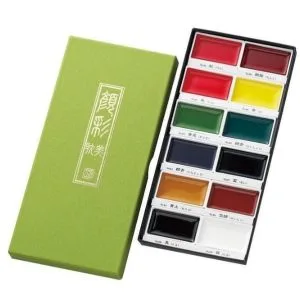 watercolour paint set with twelve assorted colours arranged in a rectangular tray alongside a green presentation box