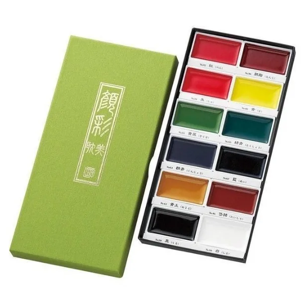 watercolour paint set with twelve assorted colours arranged in a rectangular tray alongside a green presentation box