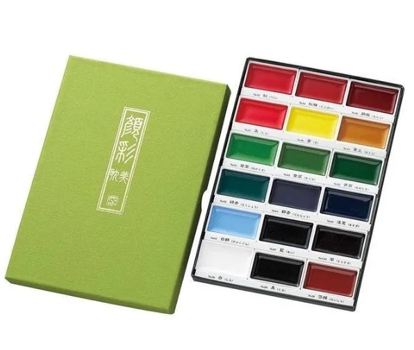 watercolour paint set with eighteen assorted colours arranged in a rectangular tray alongside a green presentation box