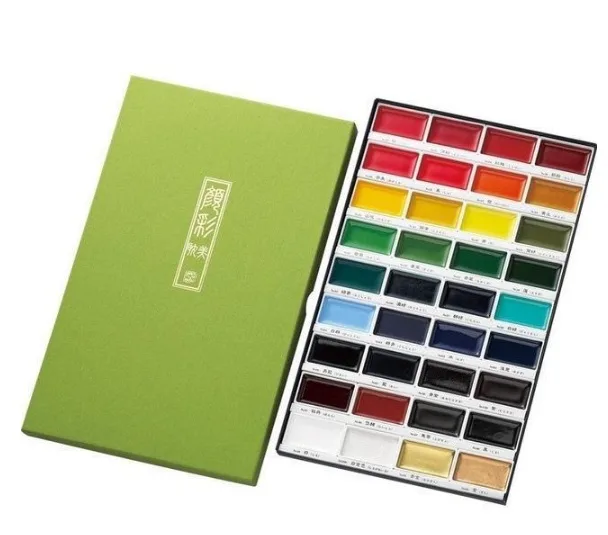 watercolour paint set with thirty-six assorted colours arranged in a rectangular tray alongside a green presentation box