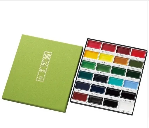 watercolour paint set with twenty-four assorted colours arranged in a rectangular tray alongside a green presentation box