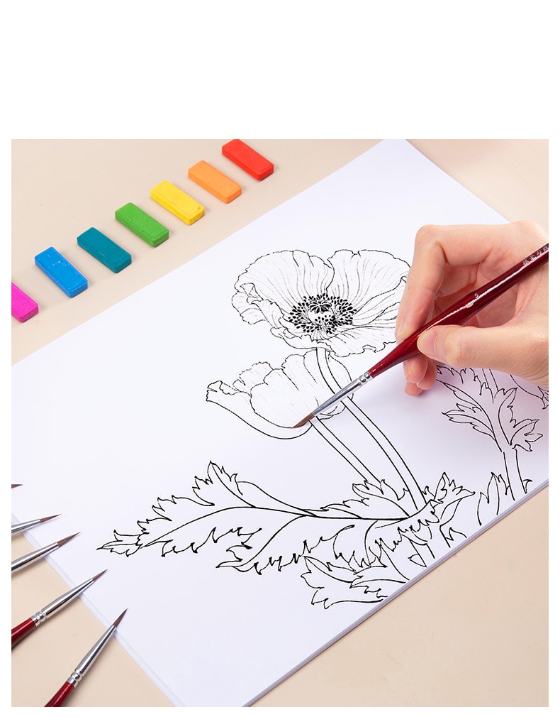 Fine detail brush set in use for outlining on canvas