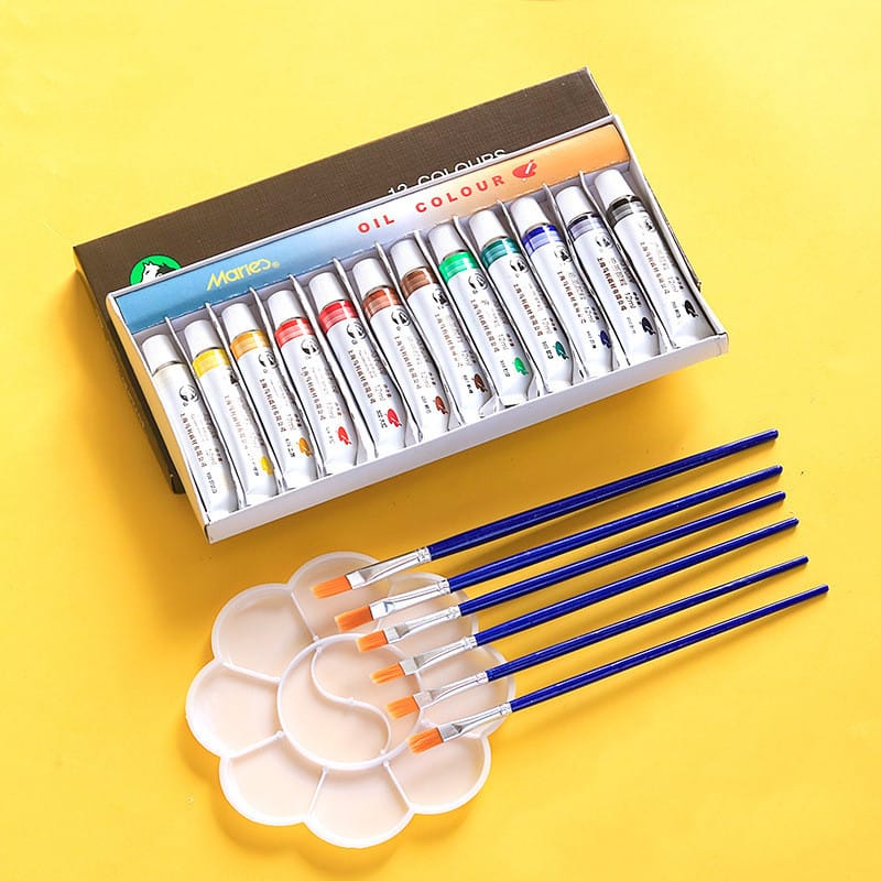 Beginner oil paint set in use on canvas with oil paints and brush