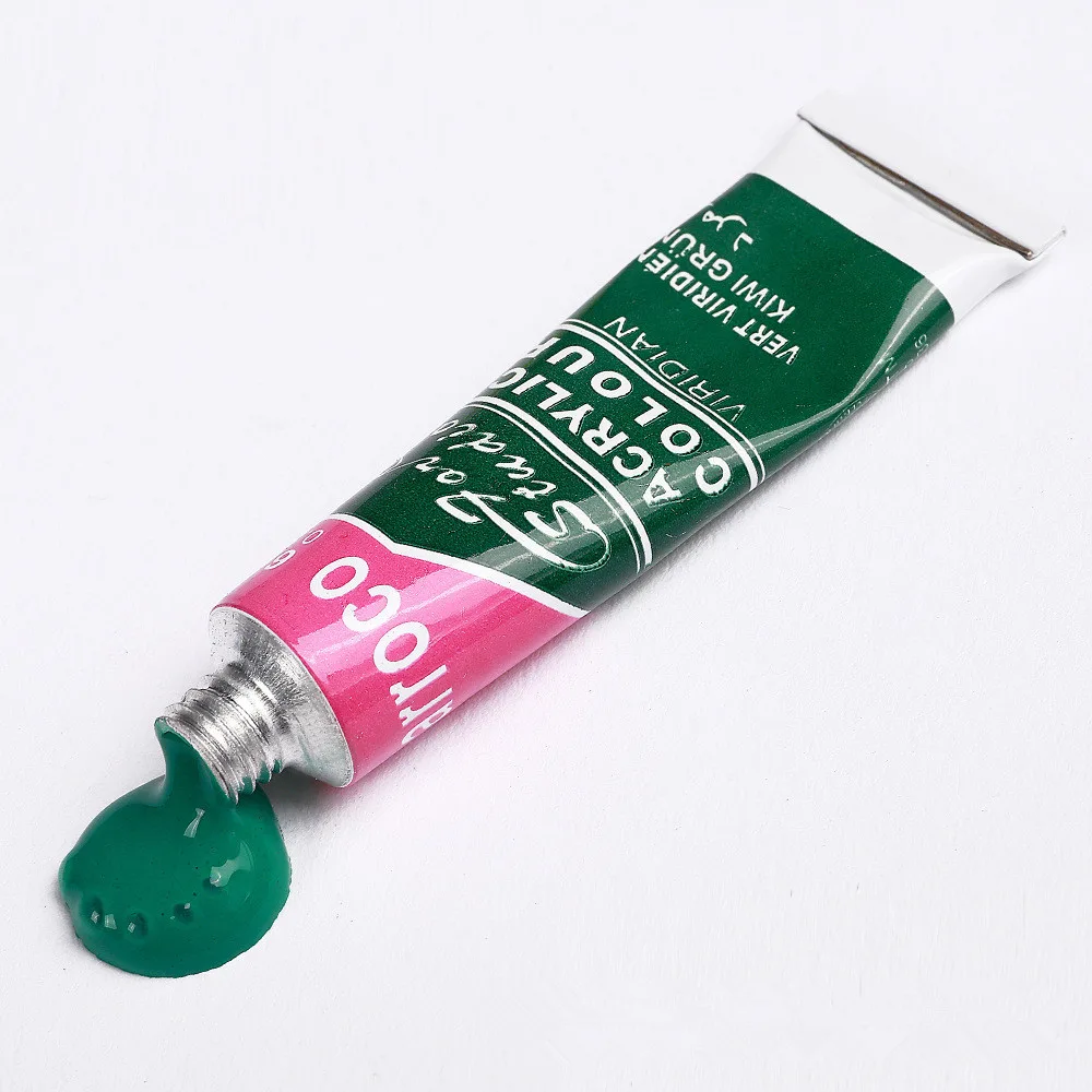 Dark green acrylic paint tube from acrylic paint set with brush with paint applied on surface