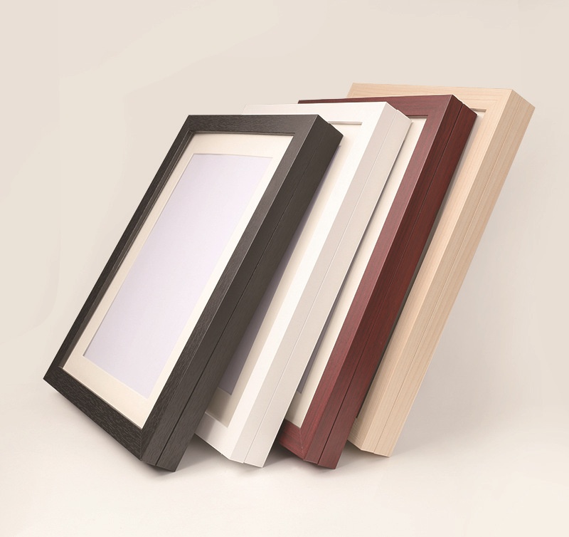 Four colour options for A4 magnetic shadow frame — black, white, rosewood, wood