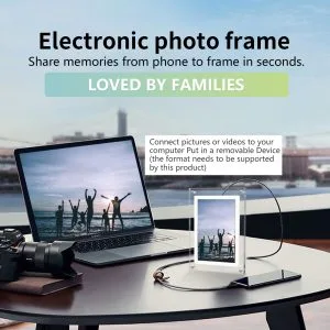 Digital electronic photo frame on desk displaying photo slideshow