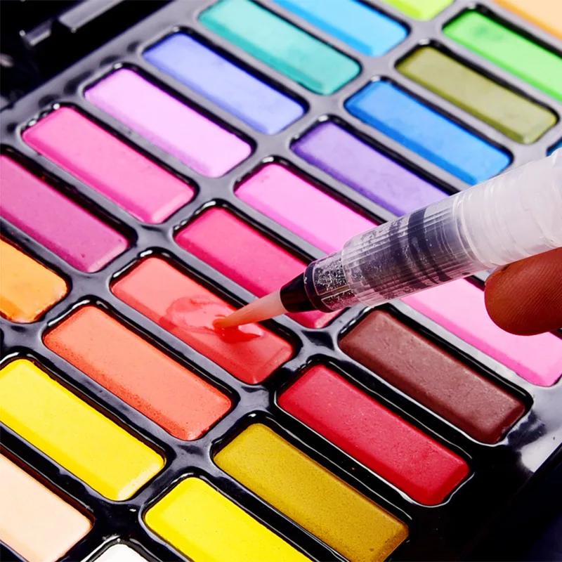 Solid watercolour paint set fountain water pens close-up detail