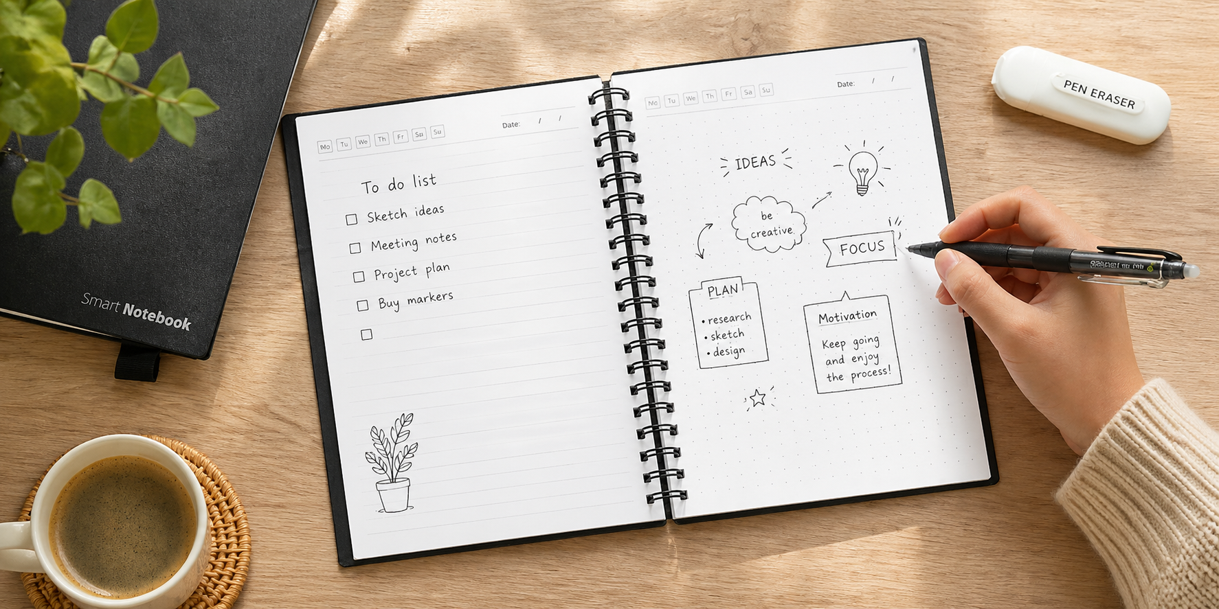 Reusable erasable notebook open on a desk with handwritten notes, doodles, and a hand writing with a pen