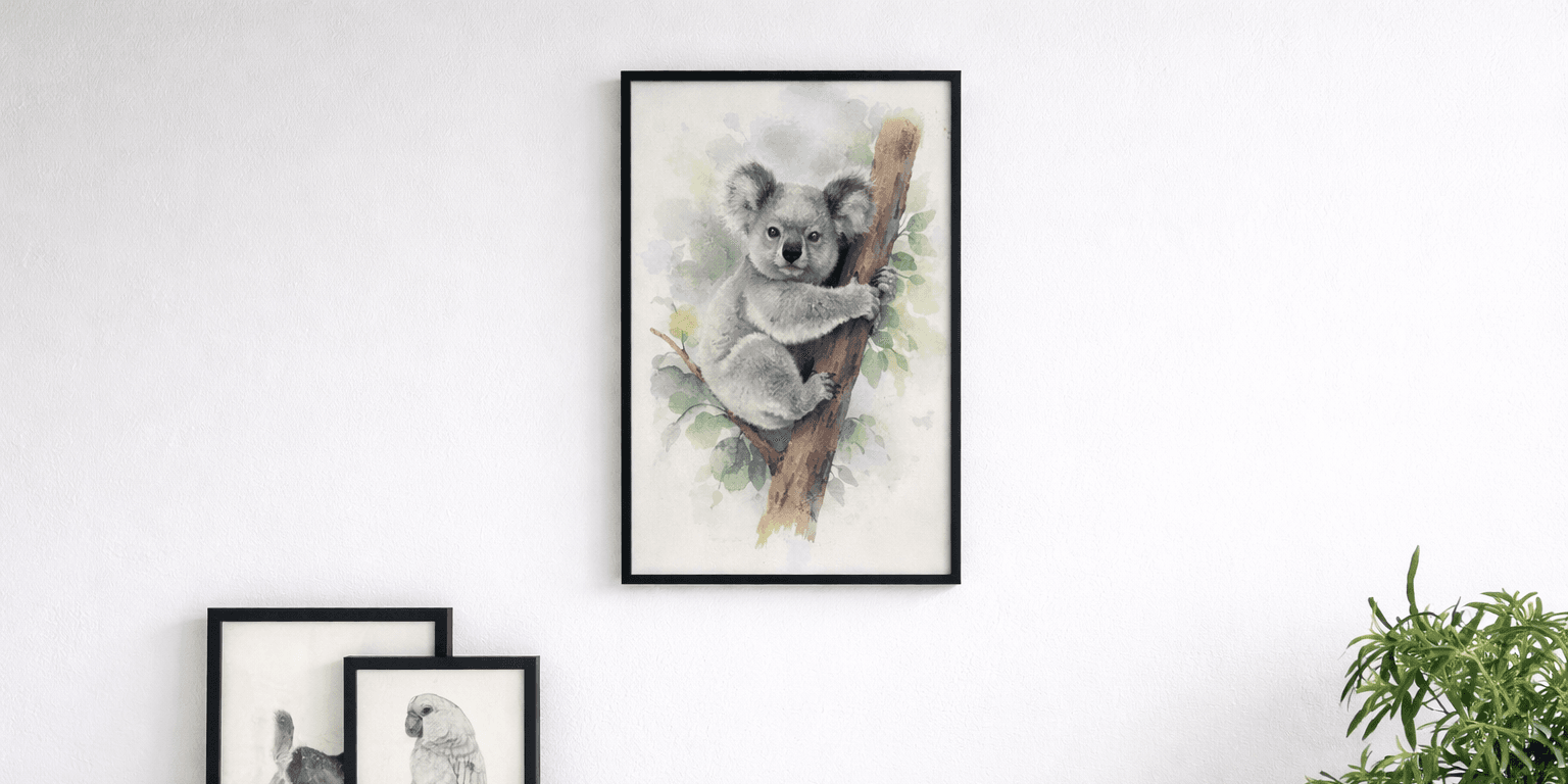 Vertical black wood picture frame hanging on a white wall displaying a watercolour painting of a koala, styled as minimalist wall decor in a horizontal hero image.