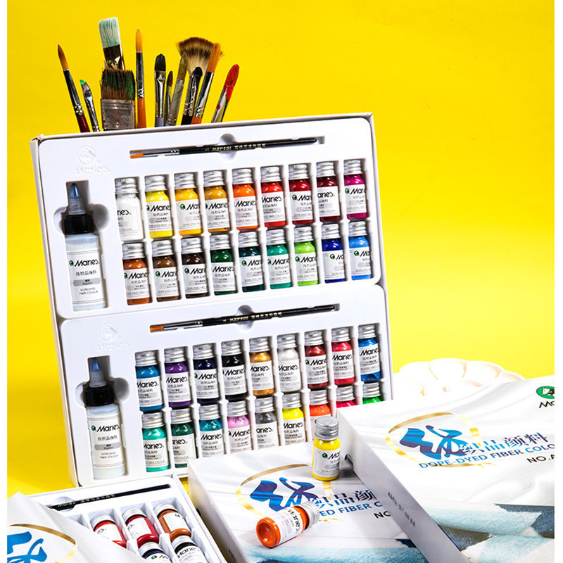 Fabric paint set box with painted T-shirt and shoe examples