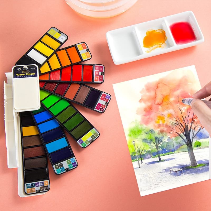Artist painting landscape with travel watercolour set and water brush pen